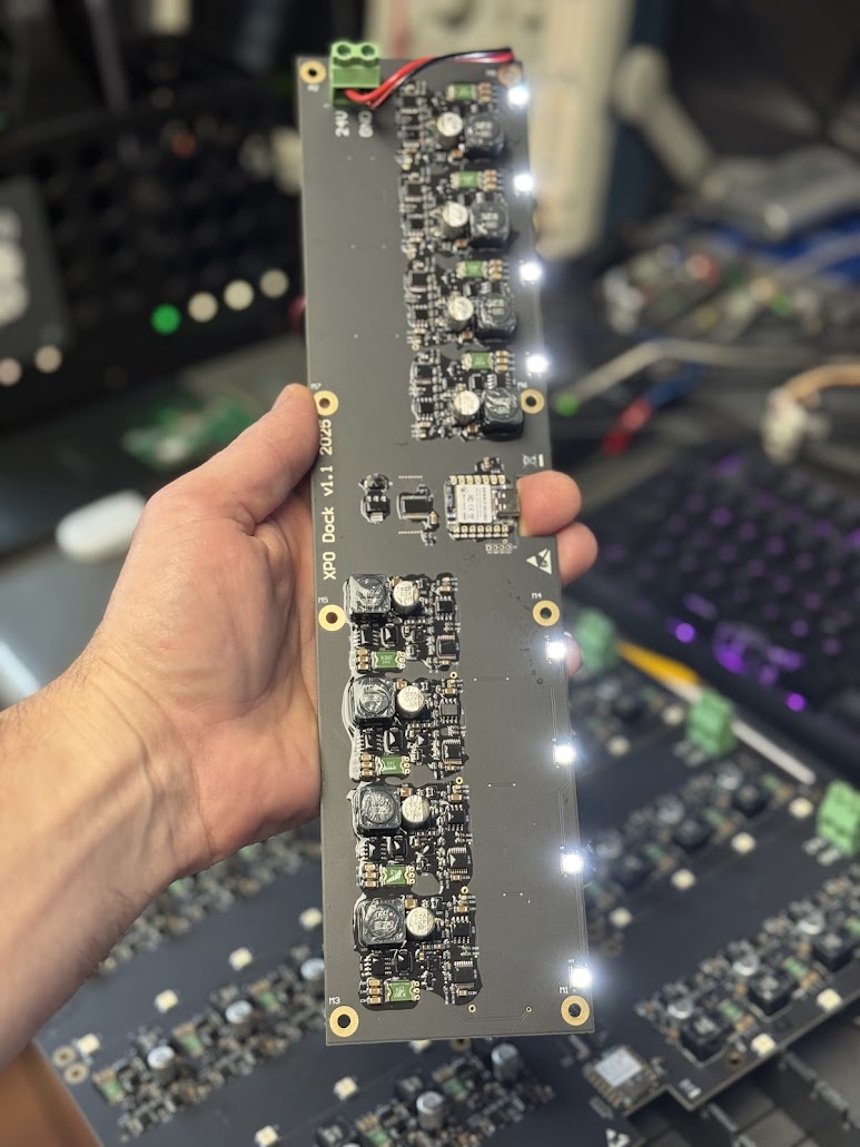 XPO dock power board on the bench with its status LEDs lit